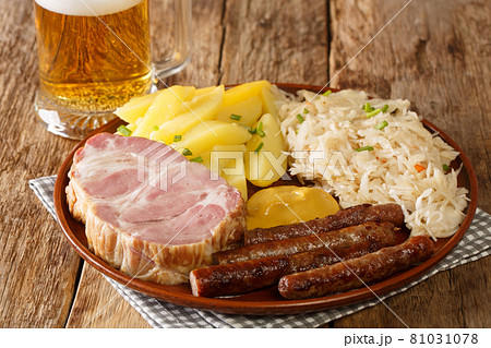 Traditional Oktoberfest recipe food sausage, Kassler pork neck, sauerkraut, mustard, boiled potatoes and light beer closeup. Horizontal Traditional Oktoberfest recipe food sausage, Kassler pork neck, sauerkraut, mustard, boiled potatoes and light beer closeup. Horizontal 81031078