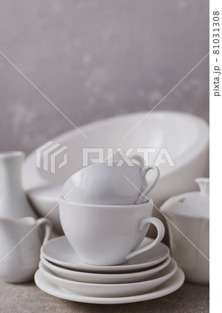 Empty crockery set or white ceramic dishes. White kitchen dishware and tableware on table 81031308