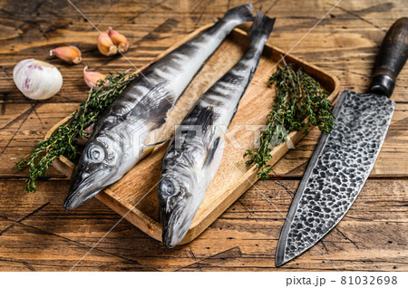 Raw mackerel icefish in a wooden tray. Wooden background. Top view Raw mackerel icefish in a wooden tray. Wooden background. Top view 81032698
