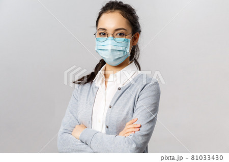 Covid19, virus, health and medicine concept. Portrait of young confident professional asian nurse, taking care of patients, wearing medical mask during quarantine coronavirus, cross hands chest Covid19, virus, health and medicine concept. Portrait of young confident professional asian nurse, taking care of patients, wearing medical mask during quarantine coronavirus, cross hands chest 81033430