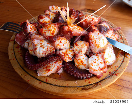 Galician-style octopus a traditional Galician dish served on the wooden plate Galician-style octopus a traditional Galician dish served on the wooden plate 81033995