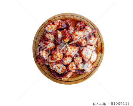 Galician-style octopus a traditional Galician dish served on the wooden plate isolated on white. 81034115