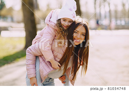 Mother with daughter playing in a spring park Mother with daughter playing in a spring park 81034748