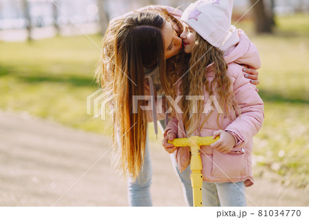 Mother with daughter in a spring park with skate Mother with daughter in a spring park with skate 81034770