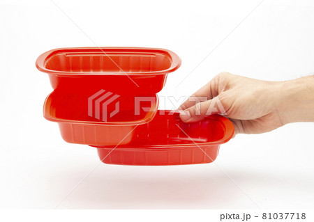 A plastic box in hand for holding food on a white background A plastic box in hand for holding food on a white background 81037718