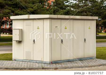 Light gray transformer box on the side of pavement Light gray transformer box on the side of pavement 81037737