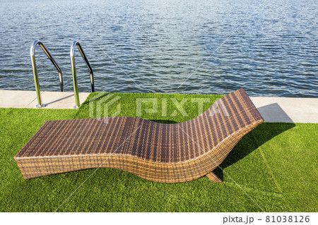 Nice bed to relax in by the pool of the hotel. 81038126