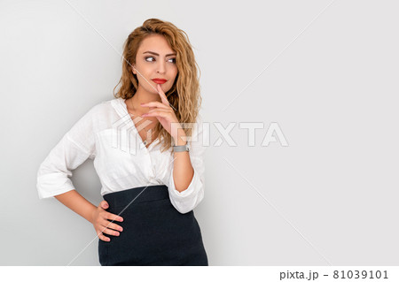 Young beautiful business woman, put her finger to her chin and thinking about problem. Young beautiful business woman, put her finger to her chin and thinking about problem. 81039101