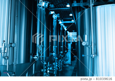 Industrial interior of modern craft brewery with chrome cylindrical metal beer tanks. Private microbrewery. Industrial interior of modern craft brewery with chrome cylindrical metal beer tanks. Private microbrewery. 81039616