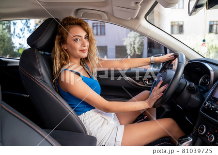 Young beautiful woman sitting on car seat and smiling. Young beautiful woman sitting on car seat and smiling. 81039725