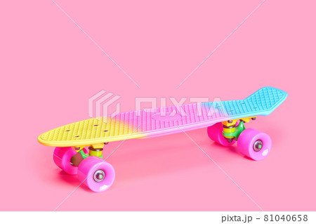 rainbow plastic Penny board skateboard isolated on pink background 81040658
