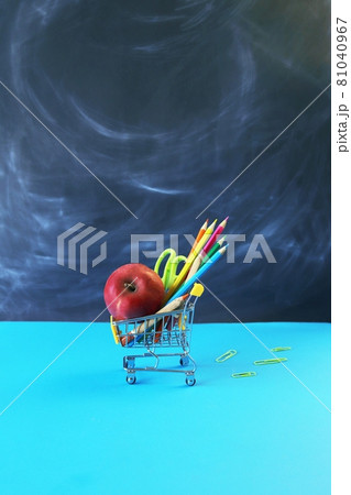 Toy trolley with stationery and apple on the background of the school board, the concept of back to school, sales of materials for study, gifts, education holidays Toy trolley with stationery and apple on the background of the school board, the concept of back to school, sales of materials for study, gifts, education holidays 81040967