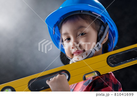 A girl is wearing an engineer costume. A girl is wearing an engineer costume. 81041699