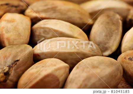 Closeup, heap of raw pistachios, unroasted still in whole shells. 81043185
