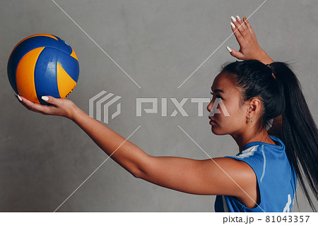 Young woman smiling volleyball player with ball Young woman smiling volleyball player with ball 81043357