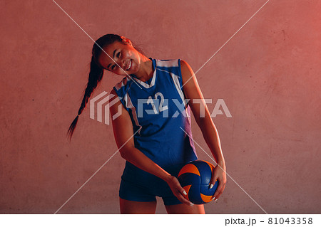 Young woman smiling volleyball player with ball 81043358