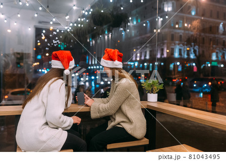 Two young girls using smartphone at the cafe. Two young girls using smartphone at the cafe. 81043495