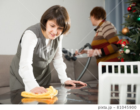 Mature mother and adult daughter are preparing room for the New Year 81045900