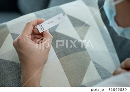 Woman using COVID-19 Antigen test. Woman using COVID-19 Antigen test. 81046889