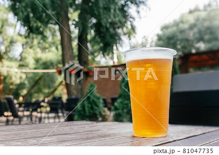 Light beer in glass on wooden table. 81047735
