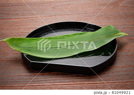 料理、食物等の背景用の笹を乗せた半月盆 81049921