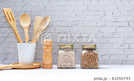 Kitchen tools and kitchenware utensil object with ingredients and mix nut on kitchen shelf wood white for healthy eat Kitchen tools and kitchenware utensil object with ingredients and mix nut on kitchen shelf wood white for healthy eat 81050745