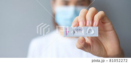 woman holding Rapid Antigen Test kit with Negative result during swab COVID-19 testing. Coronavirus Self nasal or Home test, Lockdown and Home Isolation concept woman holding Rapid Antigen Test kit with Negative result during swab COVID-19 testing. Coronavirus Self nasal or Home test, Lockdown and Home Isolation concept 81052272
