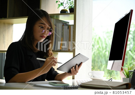 Businesswoman working with computer and using digital tablet. Businesswoman working with computer and using digital tablet. 81053457