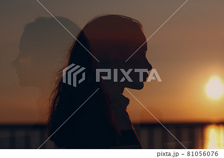 Young beautiful woman profile portrait at sunset. 81056076