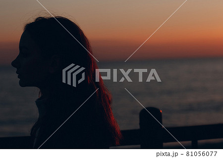 Young beautiful woman profile portrait at sunset. 81056077