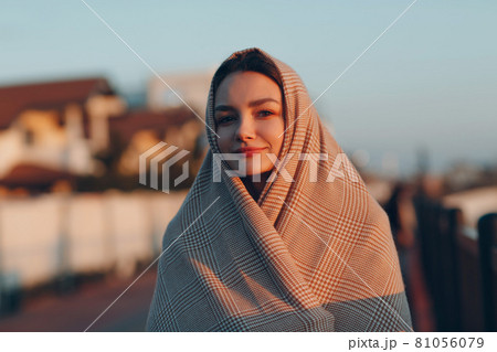 Muslim woman in headscarf portrait at sunset. 81056079