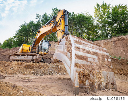 Track type loader is mining stones in opencast mining quarry. 81056136