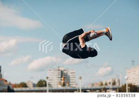 Young sporty guy doing parkour at the city street. 81056538