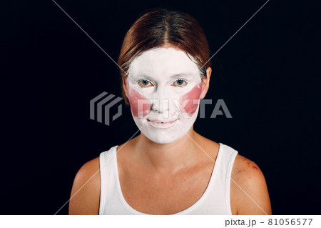 Young woman applying make-up, paints face with painting brush and makeup. How not to do make up concept 81056577