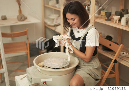 Female potter cleaning hands after work Female potter cleaning hands after work 81059138