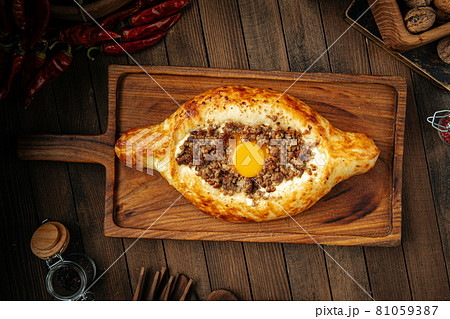 Georgian adjarian khachapuri with egg and mince 81059387