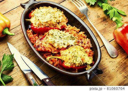 Stuffed peppers with meat on wooden background Stuffed peppers with meat on wooden background 81060704