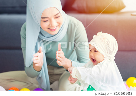 Muslim Mother happy smile enjoy playing with her baby  infant care happy together lovely home. 81060903