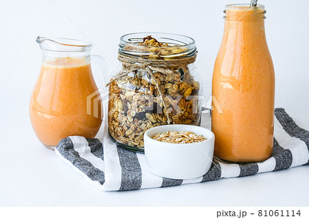 Seasonal pumpkin carrot smoothie drink detox with eco metal drinking straw Glass jar granola muesli oatmeal breakfast. Orange smoothie. Clean eating, weight loss, healthy dieting food concept 81061114