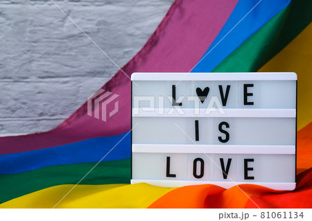 Rainbow flag with lightbox and text LOVE IS...の写真素材 [81061134