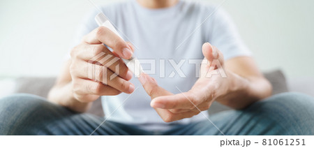 Man using lancet on finger for checking blood sugar level by Glucose meter, Healthcare and Medical, diabetes, glycemia concept 81061251