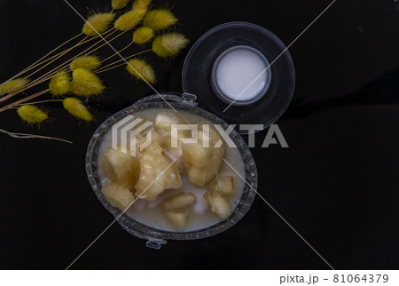 Cassava in syrup usually served with coconut milk on black floor. Traditional desserts in Thailand. 81064379