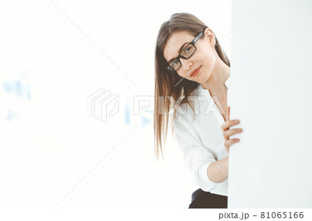 Beautiful female specialist with copy space area standing in modern office and smiling charmingly. Working on design, data analysis, plan strategy. Business people concept Beautiful female specialist with copy space area standing in modern office and smiling charmingly. Working on design, data analysis, plan strategy. Business people concept 81065166