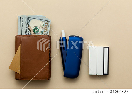 Iqos electronic blue cigarette on a beige background. Iqos electronic blue cigarette on a beige background. 81066328