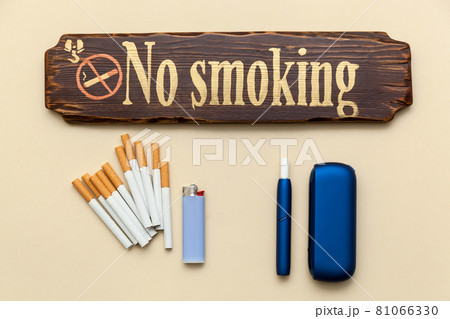 Iqos electronic blue cigarette on a beige background. Iqos electronic blue cigarette on a beige background. 81066330