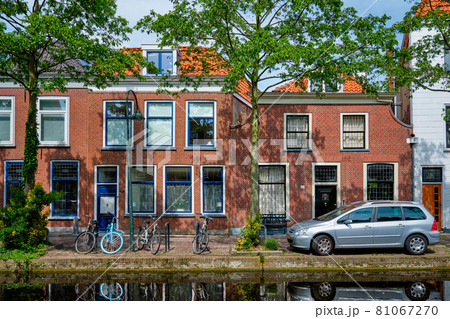 Cars on canal embankment in street of Delft. Delft, Netherlands 81067270