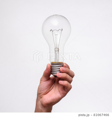 large incandescent lamp in hand close up large incandescent lamp in hand close up 81067466