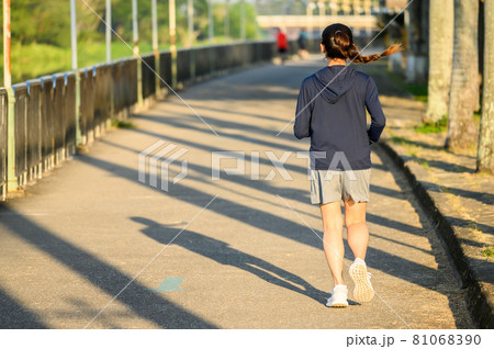 Back view of young fitness woman running in the public park. Running can significantly improve physical and mental health. Back view of young fitness woman running in the public park. Running can significantly improve physical and mental health. 81068390