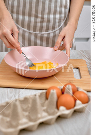Woman beats eggs in a bowl. housewife cooking on kitchen Woman beats eggs in a bowl. housewife cooking on kitchen 81070656
