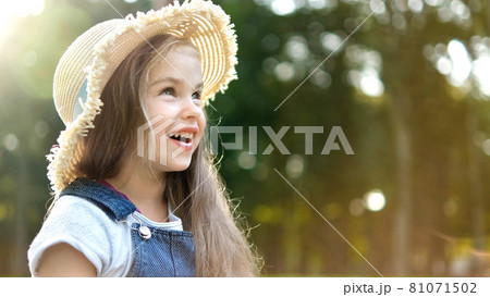 Happy little child girl in straw hat outdoors. Happy little child girl in straw hat outdoors. 81071502
